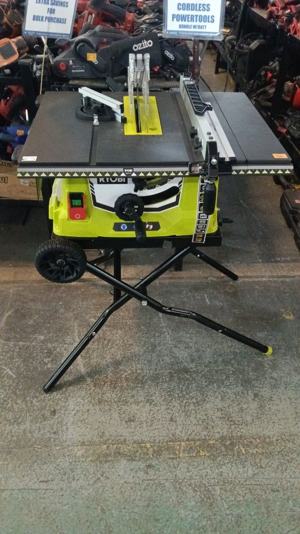 RYOBI Portable Table Saw with Rolling Stand (Category: Construction Tools & Equipment) located in Manila. Submitted by jesicahmrsantarosa (Listing ID 1469593030, Image 2). Description: - Brand: RYOBI Portable Table Saw - Color: Bright lime green and black housing - Stand: Heavy-duty folding stand with built-in wheels for easy transport - Included Accessories: Rip fence, miter gauge, and blade guard - Controls: Clear green (on) and red (off) push-