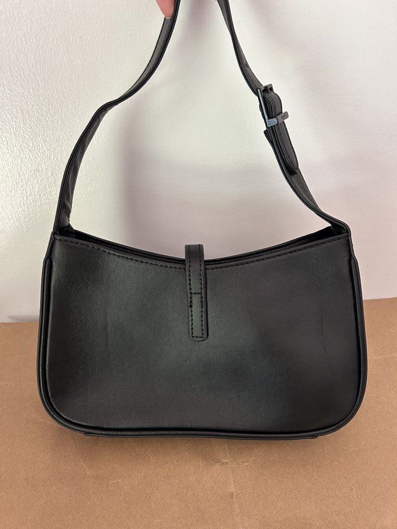 Saint Laurent Black Leather Shoulder Bag (Category: Luxury Bags & Wallets) located in Legazpi City. Submitted by jjacob_018 (Listing ID 1469681899, Image 2). Description: - Saint Laurent shoulder bag in classic black leather - Iconic metal monogram hardware on front center loop closure - Adjustable strap with metal buckle for custom fit - Clean structure with stylish tonal edge stitching - Spacious daily carry size for essentials .