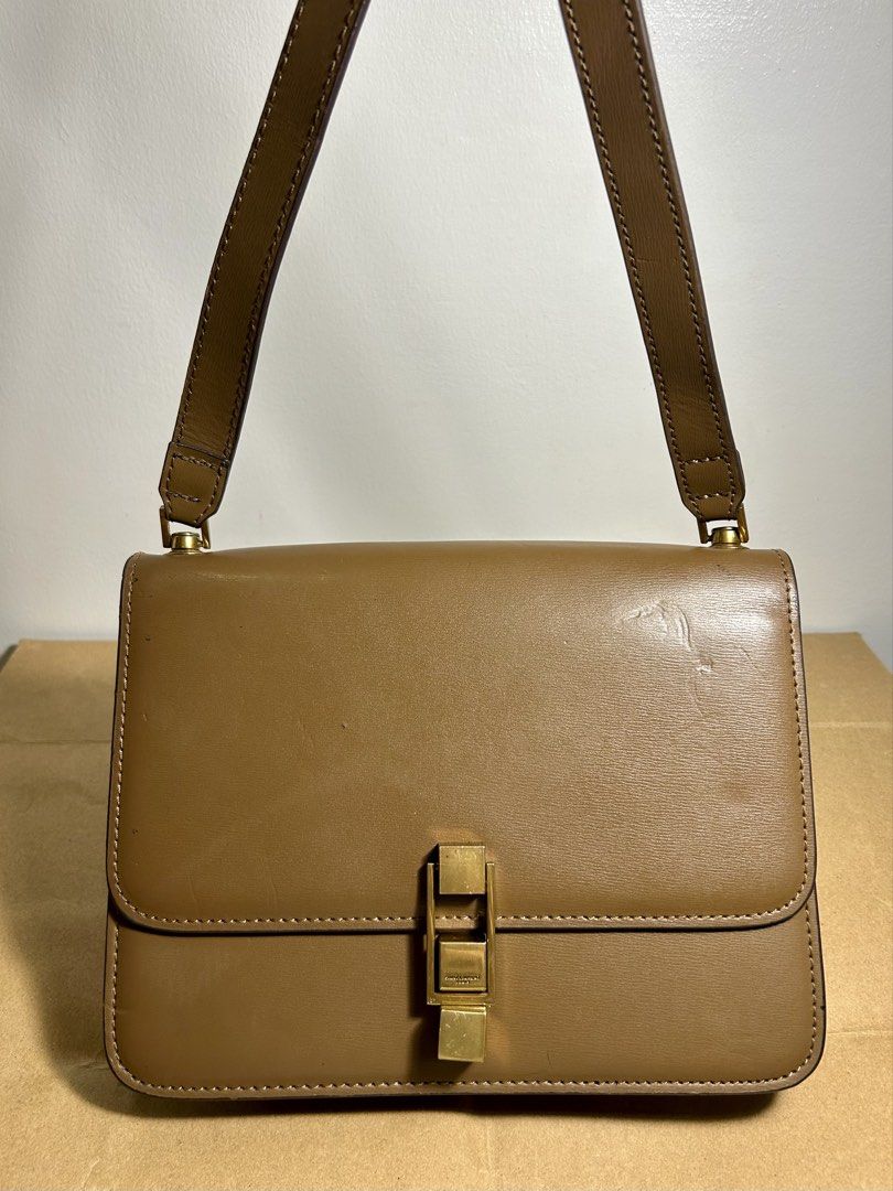 Saint Laurent Brown Leather Shoulder Bag (Category: Luxury Bags & Wallets) located in Legazpi City. Submitted by jjacob_018 (Listing ID 1469691370, Image 1). Description: - Brand: Saint Laurent - Material: Smooth tan leather with contrast stitching - Hardware: Antique brass-tone with engraved logo geometric clasp - Design: Structured shape with flap closure and adjustable buckle shoulder strap - Condition: Clean edges with some light surface scuf