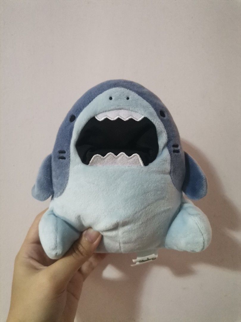 Samezu Shark Plush Toy (Category: Plushies & Soft Toys) located in Makati City. Submitted by kookybearsstuff (Listing ID 1469649986, Image 1). Description: - Authentic Samezu shark plushie by Clever Idiots - Made of soft blue plush material with stitched white teeth and wide open mouth - Original tags attached on the side and back - Clean fabric with no stains, flaws, or damage - Perfect collectible item for fans and plushie collectors - From a s
