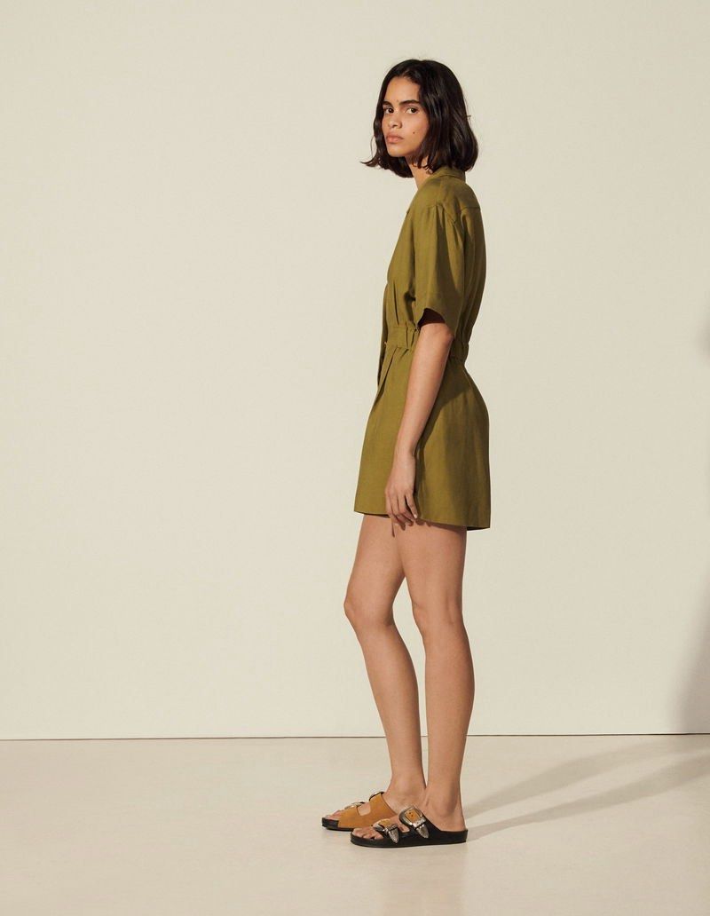 SANDRO Paris linen blend Playsuit 36 (Category: Rompers) located in Rosales. Submitted by dariang22 (Listing ID 1469600426, Image 2). Description: - Brand: Sandro - Color: Olive green - with side pockets - Style: Short-sleeve collared playsuit with front button closure - Details: Distinctive gold-toned hardware - Fit: Comfortable elasticated waist with short-cut bottoms -linen blend .