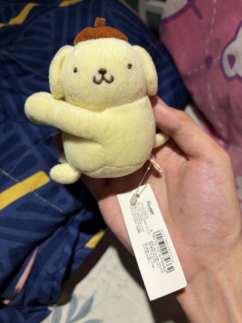 Sanrio Pompompurin plush mascot keychain with tag (Category: Plushies & Soft Toys) located in Makati City. Submitted by squishycorner (Listing ID 1469714342, Image 1). Description: - Authentic Sanrio Pompompurin plushie - Features a cute brown beret hat - Made with soft, yellow fluffy fabric - Detailed embroidered facial features - Brand new with original paper tag attached - Carefully stored in a smoke-free home.