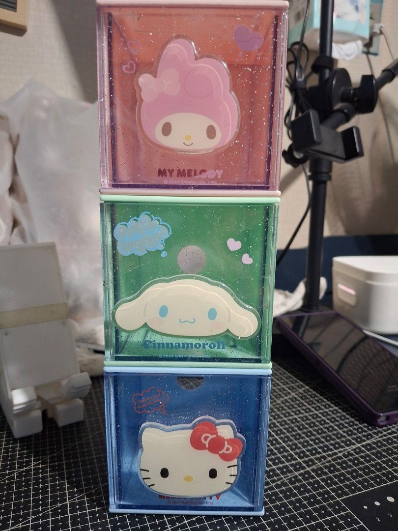 SANRIO Stackable Storage Boxes Set (Category: Storage Boxes & Baskets) located in Rizal. Submitted by emskititay (Listing ID 1469649856, Image 1). Description: Set of three stackable storage cube boxes featuring Sanrio characters. Pink My Melody box, green Cinnamoroll box, and blue Kitty box. Clear glitter sides with character faces on the front drawers. Great for organizing small stationery, trinkets, or desk accessories. Fun way to keep your de