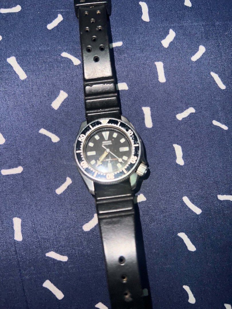 Seiko Automatic Scuba Diver's Watch (Category: Men's Watches) located in Manila. Submitted by jay_seller (Listing ID 1469751673, Image 3). Description: - Brand: Seiko Automatic Scuba Diver's Watch - Dial: Classic black with day and date display at 3 o'clock - Bezel: Rotating bezel - Case: Durable stainless steel with wave logo engraved on case back - Strap: Original black rubber dive strap - Crown: Screw-down crown - Condition: Reliable daily wea