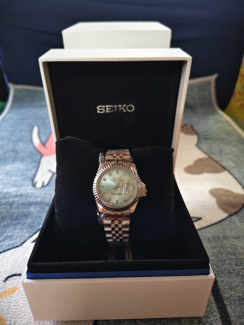 Seiko Oyster Perpetual Datejust Style Watch with Box custom mod automatic (Category: Luxury Watches) located in Manila. Submitted by rarewind.cb1244 (Listing ID 1469642713, Image 1). Description: - Brand new Seiko watch, still wrapped in protective plastic - Eye-catching light blue dial with diamond-style hour markers - Elegant rose gold tone fluted bezel and matching jubilee bracelet - Comes complete with the official branded display box and pil