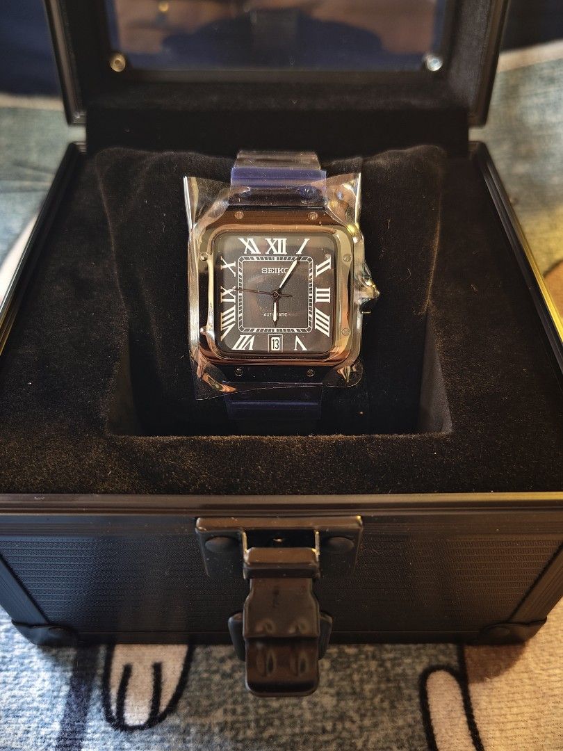Seiko Santos Triple black Square Automatic Watch in Box custom mod (Category: Luxury Watches) located in Manila. Submitted by rarewind.cb1244 (Listing ID 1469643479, Image 1). Description: - Authentic Seiko automatic watch with a unique square case design - Striking black dial with classic Roman numerals and a convenient date window at the bottom - Comfortable and stylish blue rubber strap - Includes a premium black display box with a velvet cush