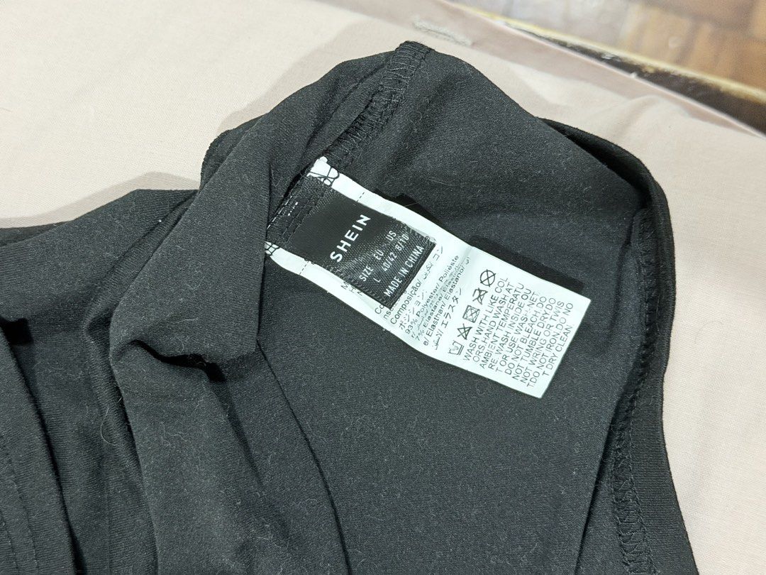SHEIN Black Off-Shoulder Ruffle Top Size L (Category: Sleeveless) located in Paranaque City. Submitted by hannahking36 (Listing ID 1469585605, Image 3). Description: - Brand: SHEIN - Style: Black strapless top with overlay ruffle detail - Size: L (Fits EU 40/42 or US 8/10) - Material: 93% polyester, 7% elastane (super stretchy and soft) - Condition: Great basic for layering or going out - Easy to pair with jeans or a skirt.