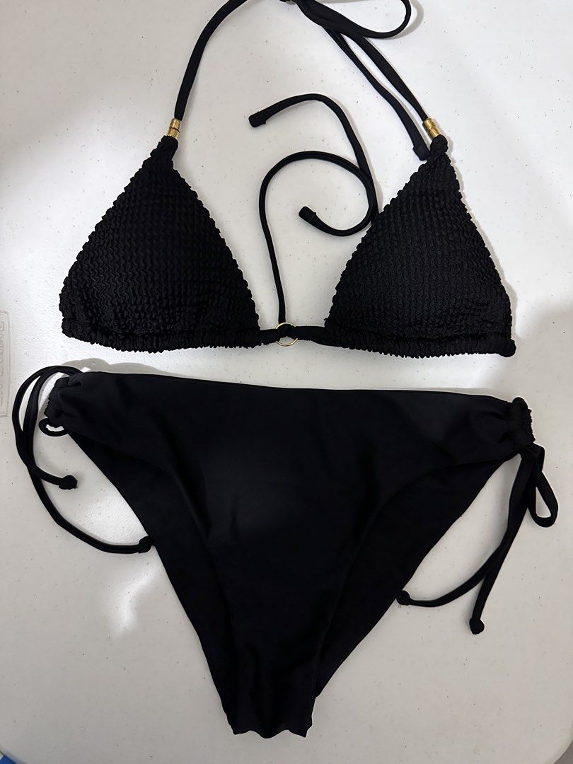 SHEIN Black Ruffle Triangle Bikini Set (Category: Bikinis & Swimsuits) located in Pasig City. Submitted by prelovedbysco (Listing ID 1469592390, Image 1). Description: - Brand: SHEIN Swim - Size: Small (tag attached) - Color: Classic Black - Fabric: Textured crinkle material - Details: Chic gold-tone hardware rings and tube accents - Top: Triangle style with halter ties and removable padding slots - Bottoms: Adjustable side ties for a custom fit 