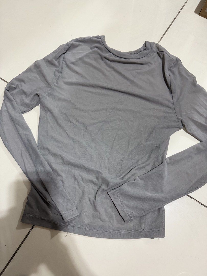 SHEIN Gray Sheer Mesh Long Sleeve Top (Category: Longsleeves) located in Manila. Submitted by buymiclothes.47 (Listing ID 1469741223, Image 2). Description: SHEIN BAE Gray Sheer Mesh Long Sleeve Top Preloved SHEIN BAE gray sheer mesh top. Cute for layering over a bralette or wearing with jeans, skirts, or trousers! * Color: Gray * Sheer / semi-transparent mesh fabric * Fitted silhouette * Long sleeves m * Round neckline * Worn once only * Flaw: S