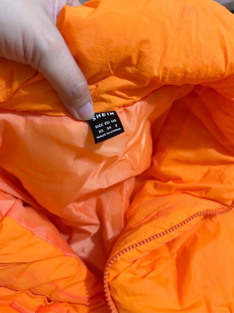 SHEIN Neon-Orange Zip Up Puffer Coat (Category: Coats, Jackets and Outerwear) located in Pasig City. Submitted by krystlemoc26502 (Listing ID 1469746470, Image 3). Description: - Brand: SHEIN - Color: Bright neon-orange - Size: XS / EU 34 / US 2 - Design: Zip-up front closure with high collar - Condition: Worn once, has minor washable discoloration from closet storage - Fit: Super cozy and warm - perfect for Mt. Pulag outfit.