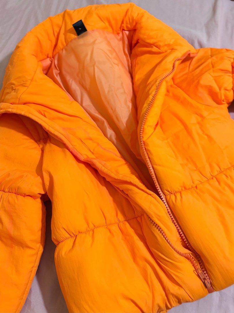 SHEIN Neon-Orange Zip Up Puffer Coat (Category: Coats, Jackets and Outerwear) located in Pasig City. Submitted by krystlemoc26502 (Listing ID 1469746470, Image 2). Description: - Brand: SHEIN - Color: Bright neon-orange - Size: XS / EU 34 / US 2 - Design: Zip-up front closure with high collar - Condition: Worn once, has minor washable discoloration from closet storage - Fit: Super cozy and warm - perfect for Mt. Pulag outfit.