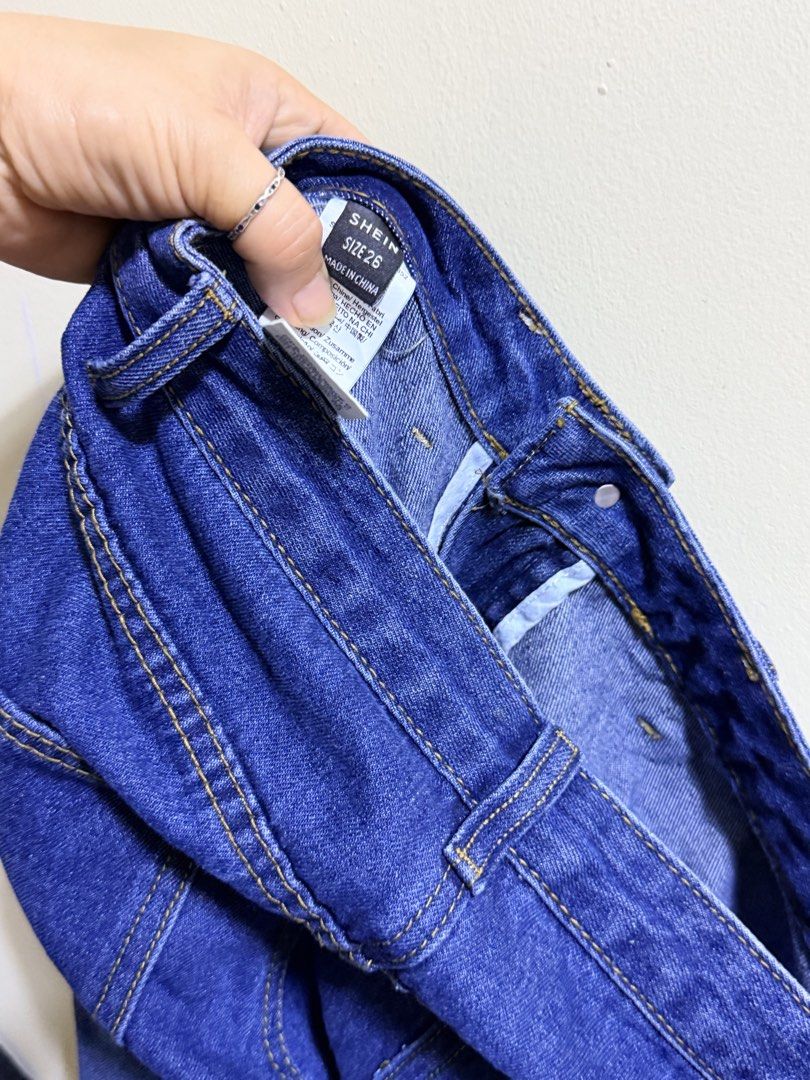 SHEIN Size 26 Distressed Cargo Denim Jeans (Category: Jeans) located in Paete. Submitted by skydruemadison (Listing ID 1469685126, Image 3). Description: - Brand/Model: SHEIN Distressed Cargo Denim Jeans - Color: Dark Blue with faded whiskering - Size: 26-28 L-36 soft denim - Fit: Wide-leg style - Features: Large front patch pockets, durable cotton denim, and contrast stitching - Closure: Button and zip fly - Condition: Great casual everyday pant