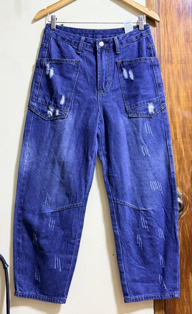 SHEIN Size 26 Distressed Cargo Denim Jeans (Category: Jeans) located in Paete. Submitted by skydruemadison (Listing ID 1469685126, Image 1). Description: - Brand/Model: SHEIN Distressed Cargo Denim Jeans - Color: Dark Blue with faded whiskering - Size: 26-28 L-36 soft denim - Fit: Wide-leg style - Features: Large front patch pockets, durable cotton denim, and contrast stitching - Closure: Button and zip fly - Condition: Great casual everyday pant