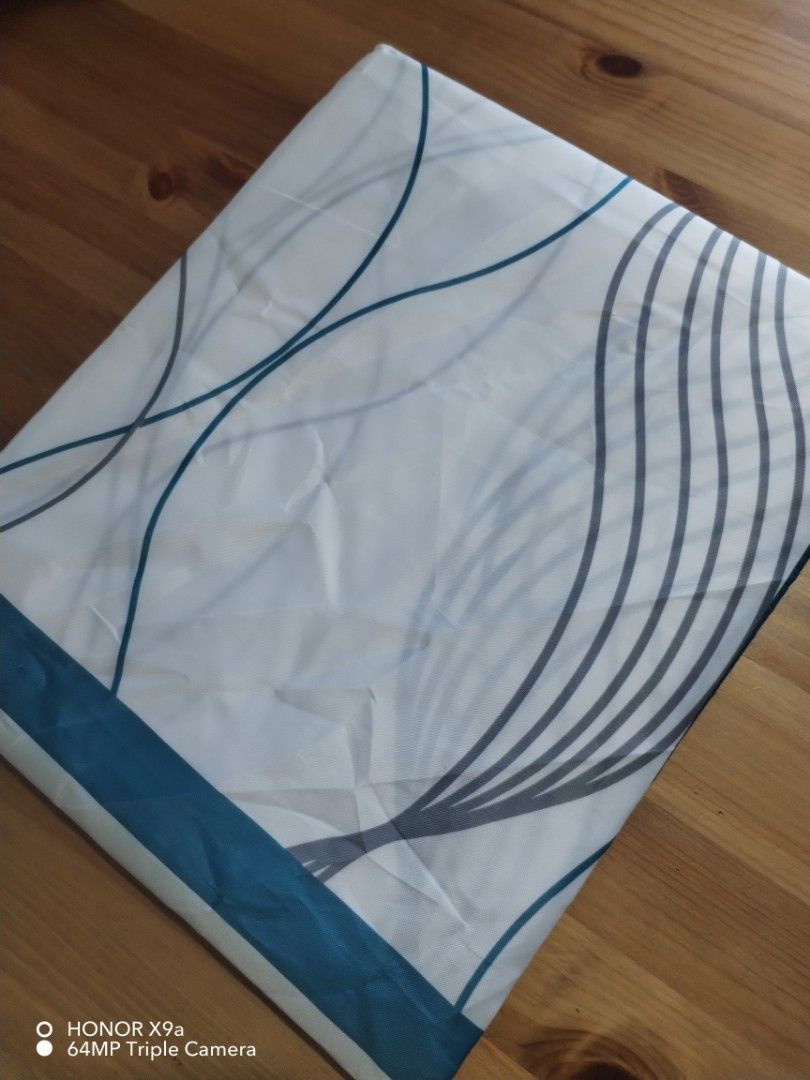 Shower curtain (Category: Bathroom & Kitchen Fixtures) located in Muntinlupa City. Submitted by arciagamaryann68 (Listing ID 1469590752, Image 1). Description: - Brand: PrettyHome - Type: Polyester Shower Curtain - Size: 72 x 72 inches - Color/Design: White with blue abstract wave pattern and teal border - Features: Waterproof, machine washable, and easy care - Inclusions: Comes complete with white curtain rings - Condition: Brand new in original