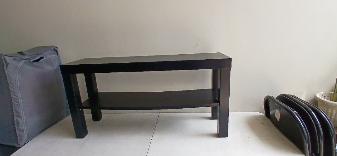 Side table (Category: TV Consoles) located in Marikina City. Submitted by darthvader888 (Listing ID 1469622396, Image 1). Description: - Color: Black - Material: Solid wood - Dimensions: ~21" L x 10.5" W x 8.5" H - Features: Open lower shelf for easy storage - Design: Clean lines, minimalist style that fits any room - Ideal for: Small TVs, gaming consoles, and media players.