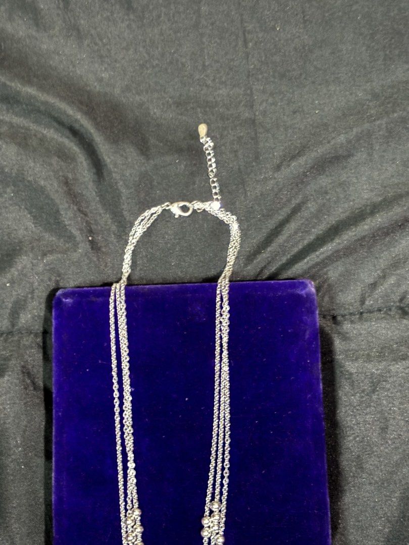 Silver Multistrand Necklace with Beaded Accents (Category: Necklaces) located in Caloocan City. Submitted by berndale_closet (Listing ID 1469587216, Image 2). Description: - Style: Silver 925 stamp layered chains with small metal beads and textured charms - Length: Approx. 19 inches with an adjustable extension chain - Closure: Secure clasp fastening - Condition: Clean metal links and fully functional hardware - Perfect for adding a chic, stacked