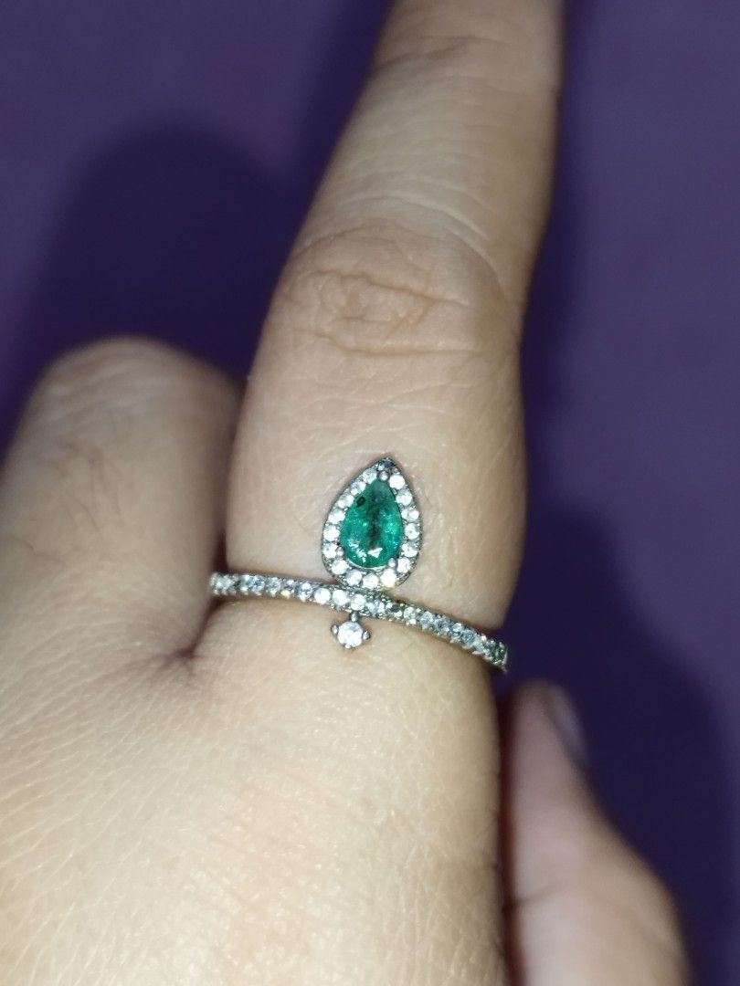 Silver Pear Cut emerald gemstone Ring with Rhinestone Band (Category: Rings) located in Manila. Submitted by Cie28 (Listing ID 1469720376, Image 2). Description: - Silver ring with a striking pear-shaped emerald center stone - Surrounded by a halo of small sparkling rhinestones - Size: Approximately 8 on the sizing stick - Condition Note: Noticeable missing stone on the band (clearly shown in the 3rd photo) - Ready to wear as-is or clean up!.