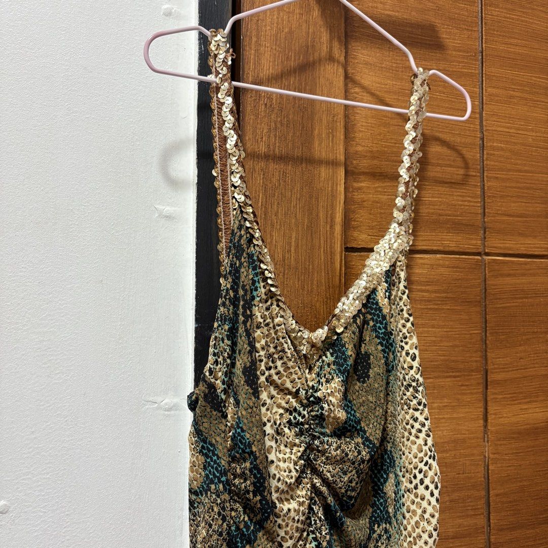 Snake Print Camisole Top with Sequins (Category: Sleeveless) located in Tuguegarao City. Submitted by shopaholiccccs (Listing ID 1469625817, Image 2). Description: small to med - Trendy mix of snake and leopard animal prints - Eye-catching shimmery gold sequin straps and V-neckline trim - Flattering ruched front design with center gathering - Comfortable, stretchy fabric with a sleeveless cut - Perfect statement piece for parties, clubs, and nigh