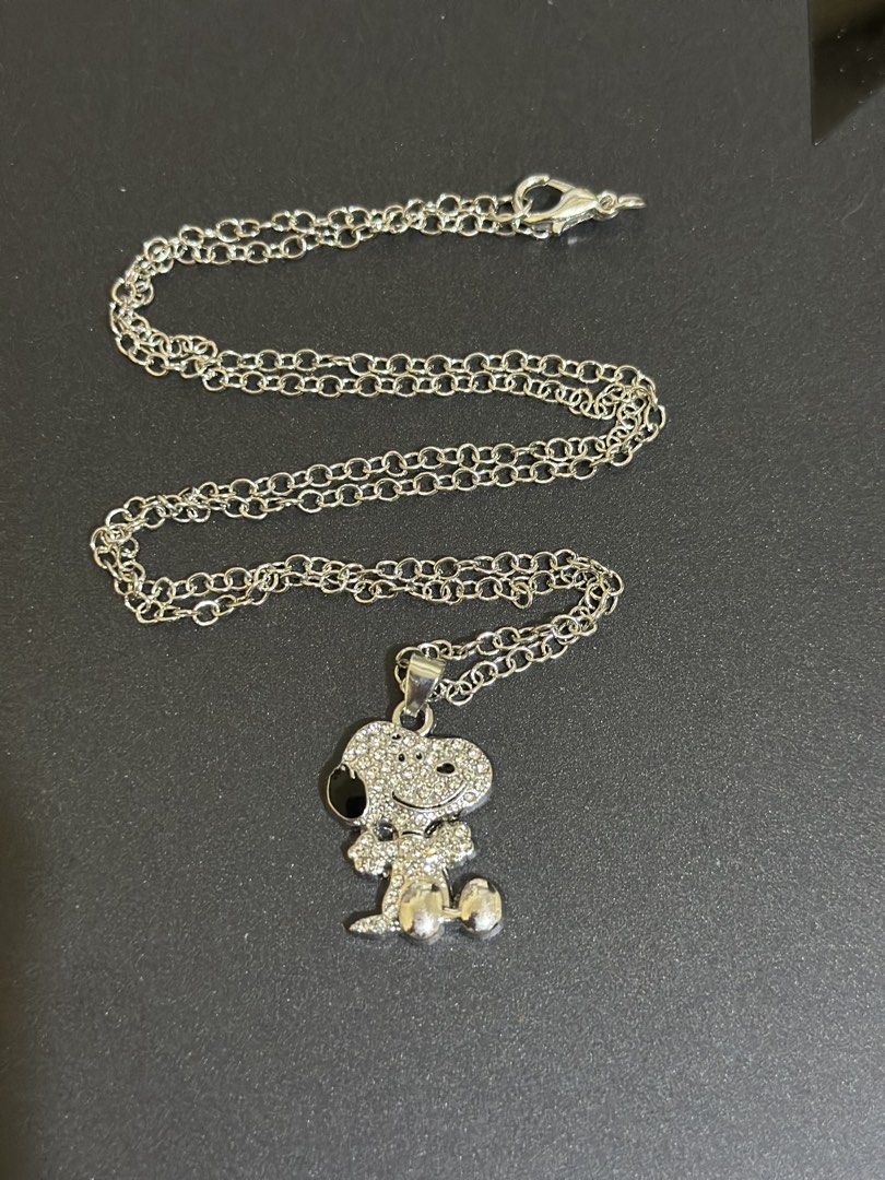 Snoopy Rhinestone Pendant Silver Chain Necklace Peanuts (Category: Necklaces) located in Quezon City. Submitted by oohsahanuhh (Listing ID 1469693855, Image 2). Description: Payment- GCASH or BDO Delivery Tktok chckout or Shpee chkout Meet up: SM North - Design: Silver-toned chain with a medium-sized, rhinestone-paved Snoopy pendant - Details: Features cute black enamel accent on the ear and sparkly crystal stones - Closure: Secure lobster clasp 