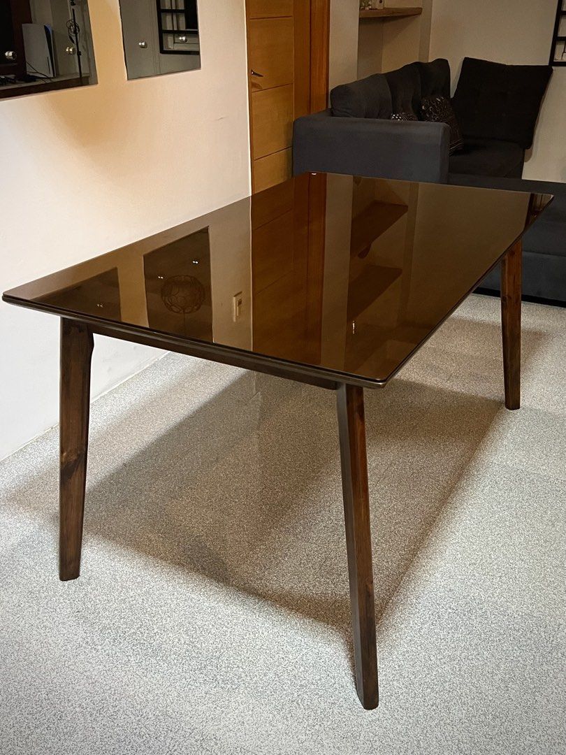 Solid Malaysian Wood 4-Seater Size Dining Table with Tempered Glass Top (Category: Tables & Sets) located in Baguio. Submitted by the_mixed_locker (Listing ID 1469720242, Image 2). Description: ✨ Pre-loved Solid Wood Dining Set for Sale! ✨ Selling our well-loved, heavy-duty Wooden Dining Table Set. It comes with 2 matching cushioned chairs, but the table size can easily fit up to 4 chairs if you have extra seats! Very elegant and modern dark tint