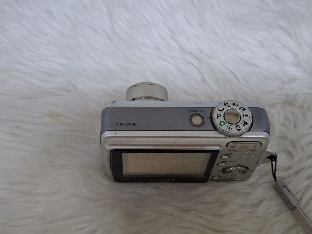 Sony Cyber-shot DSC-S500 6.0 Mega Pixels Digital Camera (Category: Cameras) located in Manila. Submitted by jonrick.co (Listing ID 1469590980, Image 3). Description: - Model: Sony Cyber-shot DSC-S500 (Silver) - Resolution: 6.0 Megapixels with 3x Optical Zoom - Display: 2.4-inch LCD monitor - Condition: Powers on and displays menus properly, with minor cosmetic wear from regular use - Power Source: Uses standard AA batteries - Inclusion: Wrist str