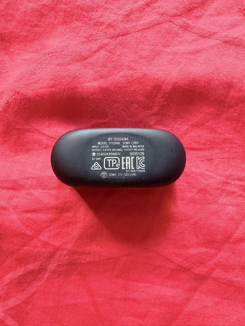 Sony WF-1000XM4 Wireless Earbuds (Category: Headphones & Headsets) located in San Pedro. Submitted by dennis697 (Listing ID 1469617639, Image 3). Description: - Model: Sony WF-1000XM4 (Black) - Includes: Charging case (USB-C port) and both earbuds - Condition: Standard daily wear on the casing, fully functional - Details: Model number and battery specs printed underneath the case - RFS: Upgraded / Decluttering - Meet-ups or shipping available via