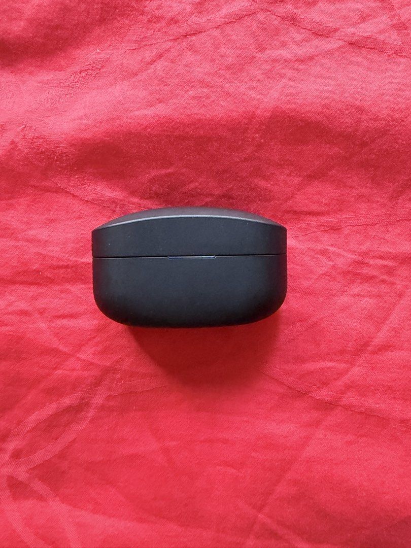 Sony WF-1000XM4 Wireless Earbuds (Category: Headphones & Headsets) located in San Pedro. Submitted by dennis697 (Listing ID 1469617639, Image 2). Description: - Model: Sony WF-1000XM4 (Black) - Includes: Charging case (USB-C port) and both earbuds - Condition: Standard daily wear on the casing, fully functional - Details: Model number and battery specs printed underneath the case - RFS: Upgraded / Decluttering - Meet-ups or shipping available via