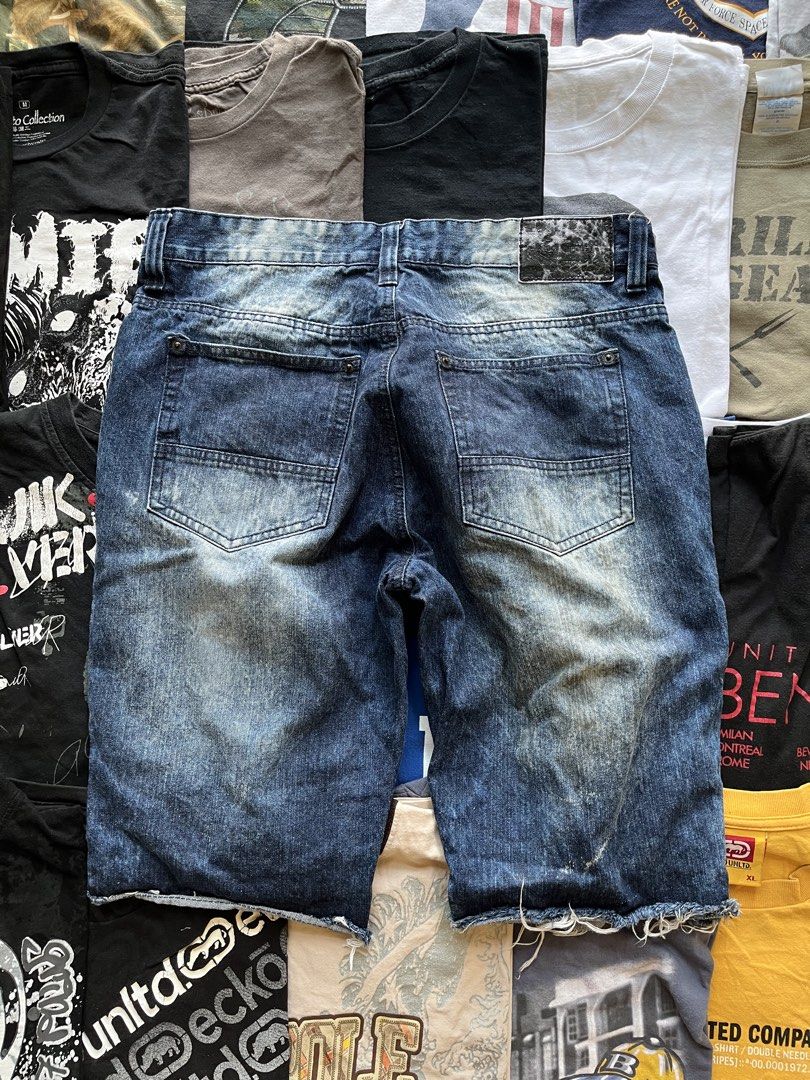 Southpole Distressed Denim Shorts Size 34 (Category: Shorts) located in Baao. Submitted by plainclothesdept (Listing ID 1469696911, Image 2). Description: southpole cropped ragged shorts waist - 34 in. length - 23 in. hem - 9 in. no flaws - Brand: Southpole - Size: 34 - Wash: Dark wash - Details: Heavy distressing, rips on both legs, raw cut-off hem - Features: Five-pocket styling, button fly - Condition: Made in Bangladesh, comfortable fit for c