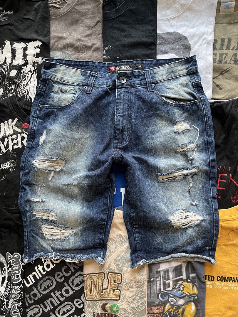 Southpole Distressed Denim Shorts Size 34 (Category: Shorts) located in Baao. Submitted by plainclothesdept (Listing ID 1469696911, Image 1). Description: southpole cropped ragged shorts waist - 34 in. length - 23 in. hem - 9 in. no flaws - Brand: Southpole - Size: 34 - Wash: Dark wash - Details: Heavy distressing, rips on both legs, raw cut-off hem - Features: Five-pocket styling, button fly - Condition: Made in Bangladesh, comfortable fit for c