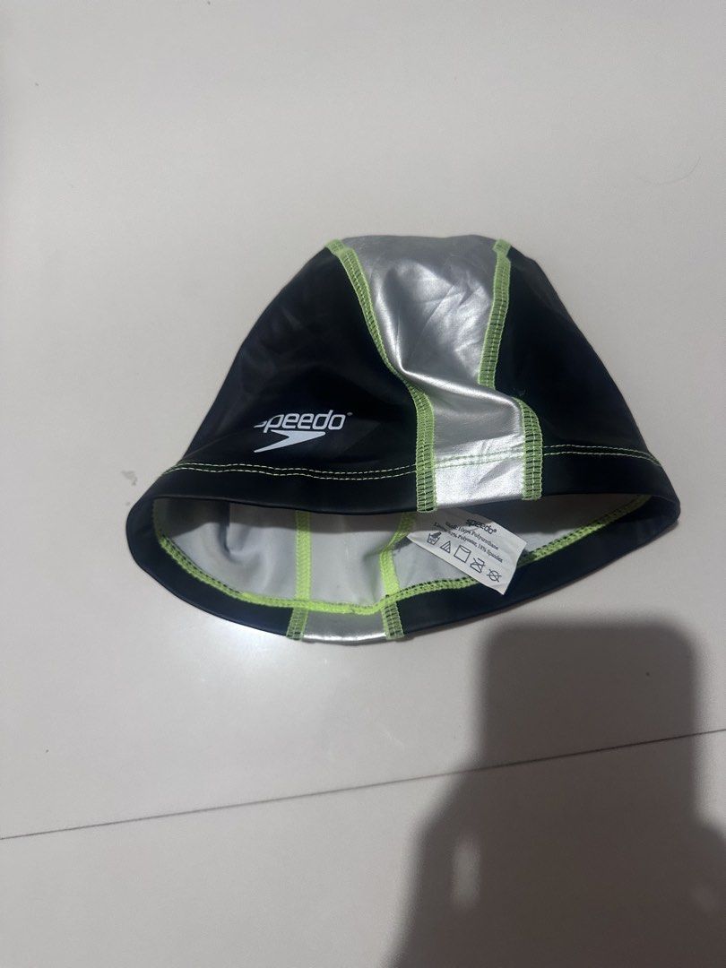Speedo Swim Cap Black Silver Green (Category: Caps & Hats) located in Calamba. Submitted by thriftniyins (Listing ID 1469615881, Image 3). Description: - Brand: Speedo - Color: Black and silver with neon green stitching - Design: Distinct center stripe with white Speedo logo - Material: Polyurethane shell with polyester and spandex lining - Condition: Clean fabric, ready for the pool - plus sf.