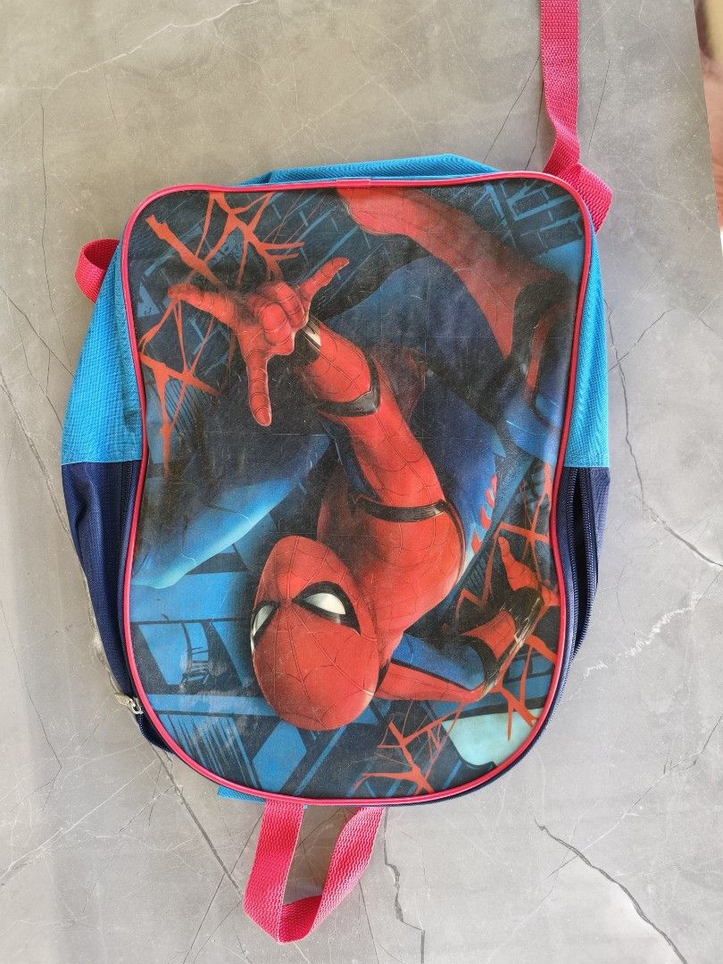 Spider-Man Kids Backpack Blue Red (Category: Backpacks) located in Munoz. Submitted by toy_zone (Listing ID 1468501558, Image 2). Description: - Design: Eye-catching Spider-Man graphic print on the front with blue and dark blue panels - Straps: Vibrant bright pink straps with adjustable buckles for a comfortable fit - Closure: Secure zip closure for the main compartment - Usage: Ideal size for school, daily outings, and casual use - Condition: Go
