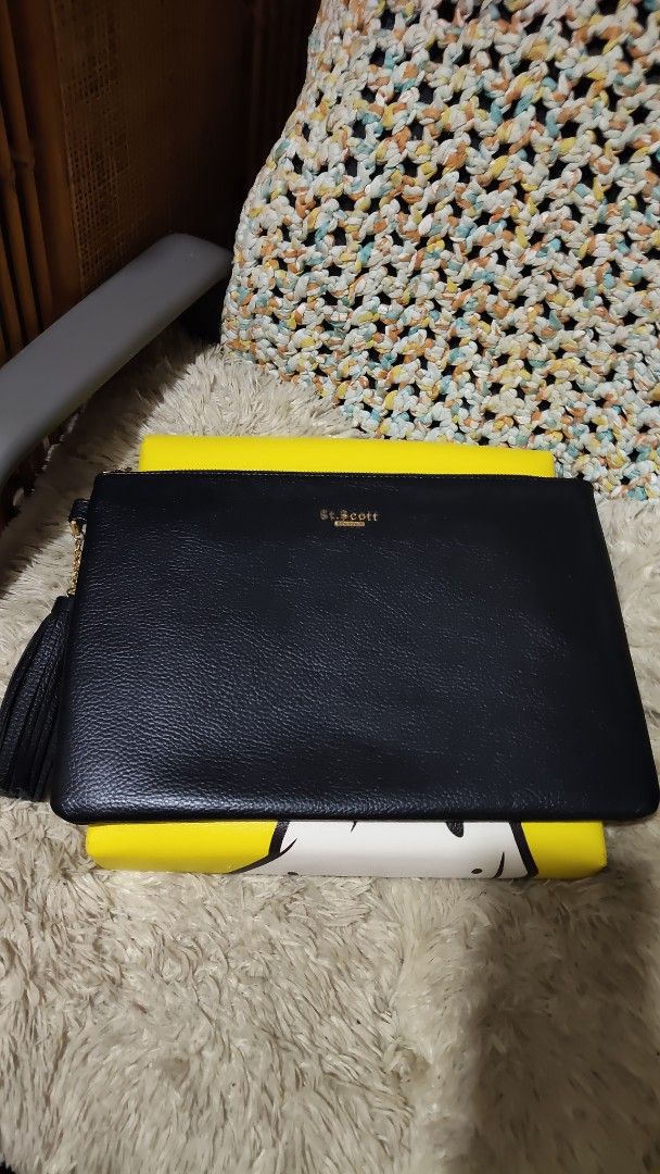 St. Scott London Black Leather Clutch (Category: Clutches) located in Cebu City. Submitted by lumaynojes00490 (Listing ID 1469683385, Image 2). Description: - Brand: St. Scott London - Material: Premium black leather with textured pebble grain finish - Hardware: Elegant gold-tone hardware with stamped gold lettering on the front - Closure: Secure top zip closure with a stylish chained tassel zipper pull - Capacity: Practical daily size, fits your