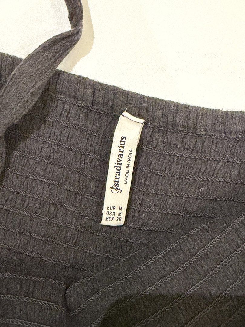 Stradivarius Black Smocked Jumpsuit Size M (Category: Jumpsuits) located in Muntinlupa City. Submitted by henlo03 (Listing ID 1469601887, Image 3). Description: - Brand: Stradivarius - Size: M (EUR M, USA M, MEX 28) - Made in India - Color: Black - Smocked bodice with decorative front buttons - Thin straps and wide-leg crop fit - Lightweight, comfortable fabric - Versatile for casual or dressy looks.