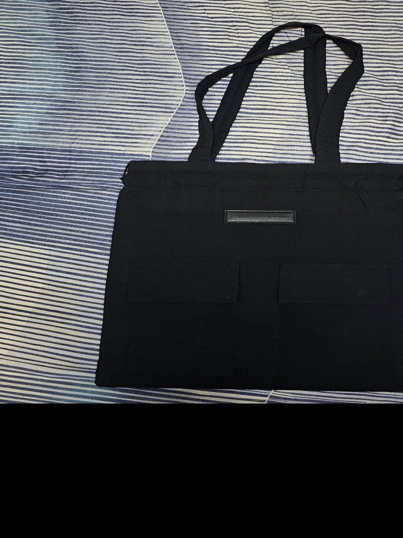 Straightforward Black Tote Bag with Pockets (Category: Tote Bags) located in Manila. Submitted by naserrano (Listing ID 1469723475, Image 2). Description: - Color: Classic black - Material: Durable, high-quality fabric - Straps: Sturdy double straps for comfortable carry - Pockets: Multiple front exterior patch pockets for easy organization - Design: Minimalist label patch on the front - Storage: Deep main compartment ideal for everyday essential