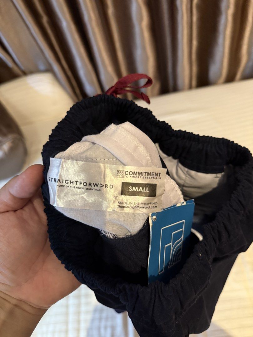 Straightforward Navy Blue Shorts Size Small (Category: Shorts) located in Muntinlupa City. Submitted by golf823 (Listing ID 1469683820, Image 3). Description: - Color: Navy Blue - Size: Small - Condition: Brand new with tags still attached - Waist: Elastic waistband with contrasting red drawstring - Pockets: Convenient side pockets and one right back pocket - Origin: Made in the Philippines - Fit: Everyday casual fit.