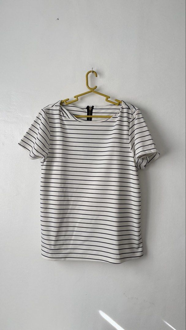 Striped Top (Category: Blouses) located in Cainta. Submitted by getsometin (Listing ID 1469681804, Image 1). Description: - Classic black and white horizontal stripe design - Elegant boat neckline and comfortable short sleeves - Trendy exposed black zipper detail on the upper back - Soft, stretchy material for a great fit - Excellent, clean condition with zero stains or damage - Size and measurements available upon request—feel free to chat!.