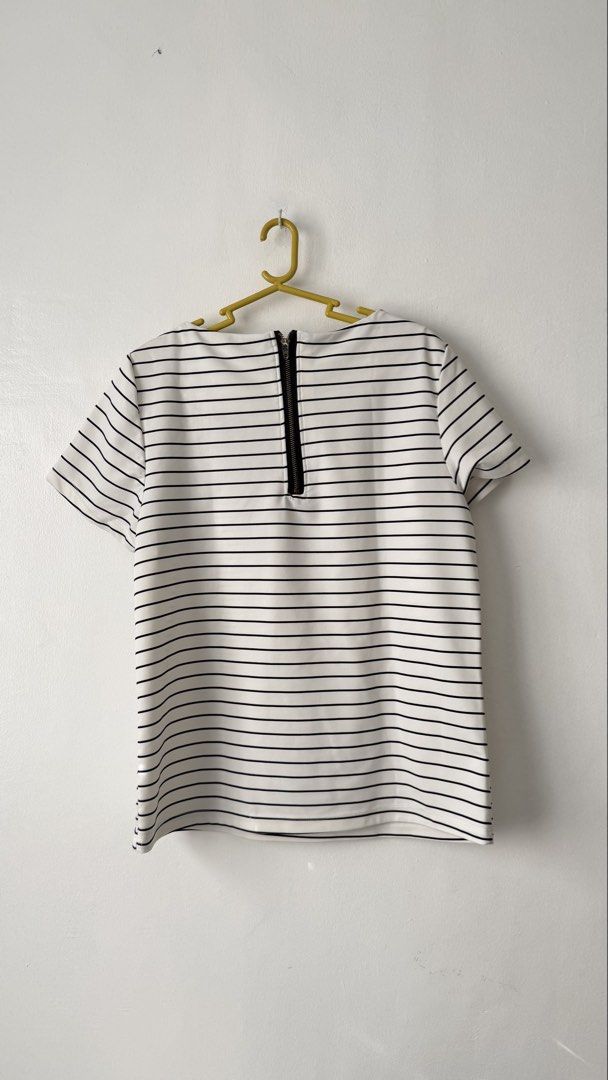 Striped Top (Category: Blouses) located in Cainta. Submitted by getsometin (Listing ID 1469681804, Image 2). Description: - Classic black and white horizontal stripe design - Elegant boat neckline and comfortable short sleeves - Trendy exposed black zipper detail on the upper back - Soft, stretchy material for a great fit - Excellent, clean condition with zero stains or damage - Size and measurements available upon request—feel free to chat!.