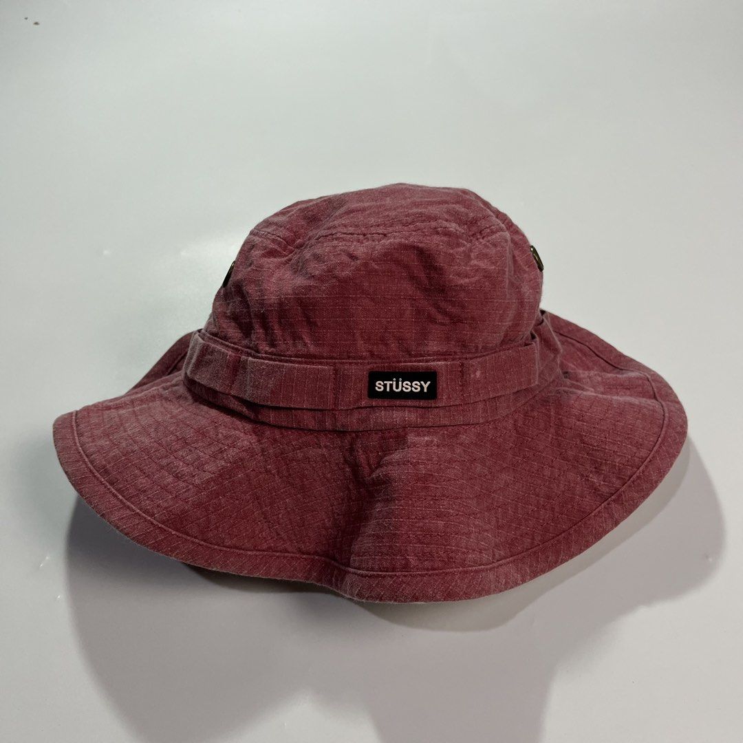 Stüssy Maroon Bucket Hat with Drawstring (Category: Caps & Hats) located in Iloilo. Submitted by kahit.ano.na.lang (Listing ID 1469736056, Image 1). Description: - Brand: Stüssy - Color: Maroon - Material: 100% cotton with inner mesh lining - Features: Adjustable black chin strap with toggle and front woven logo label - Origin: Made in Bangladesh for Stüssy Japan.