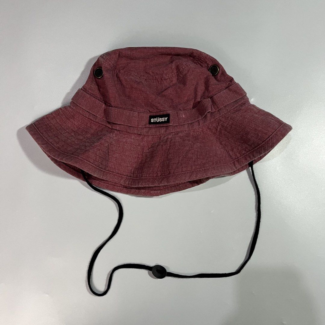 Stüssy Maroon Bucket Hat with Drawstring (Category: Caps & Hats) located in Iloilo. Submitted by kahit.ano.na.lang (Listing ID 1469736056, Image 2). Description: - Brand: Stüssy - Color: Maroon - Material: 100% cotton with inner mesh lining - Features: Adjustable black chin strap with toggle and front woven logo label - Origin: Made in Bangladesh for Stüssy Japan.