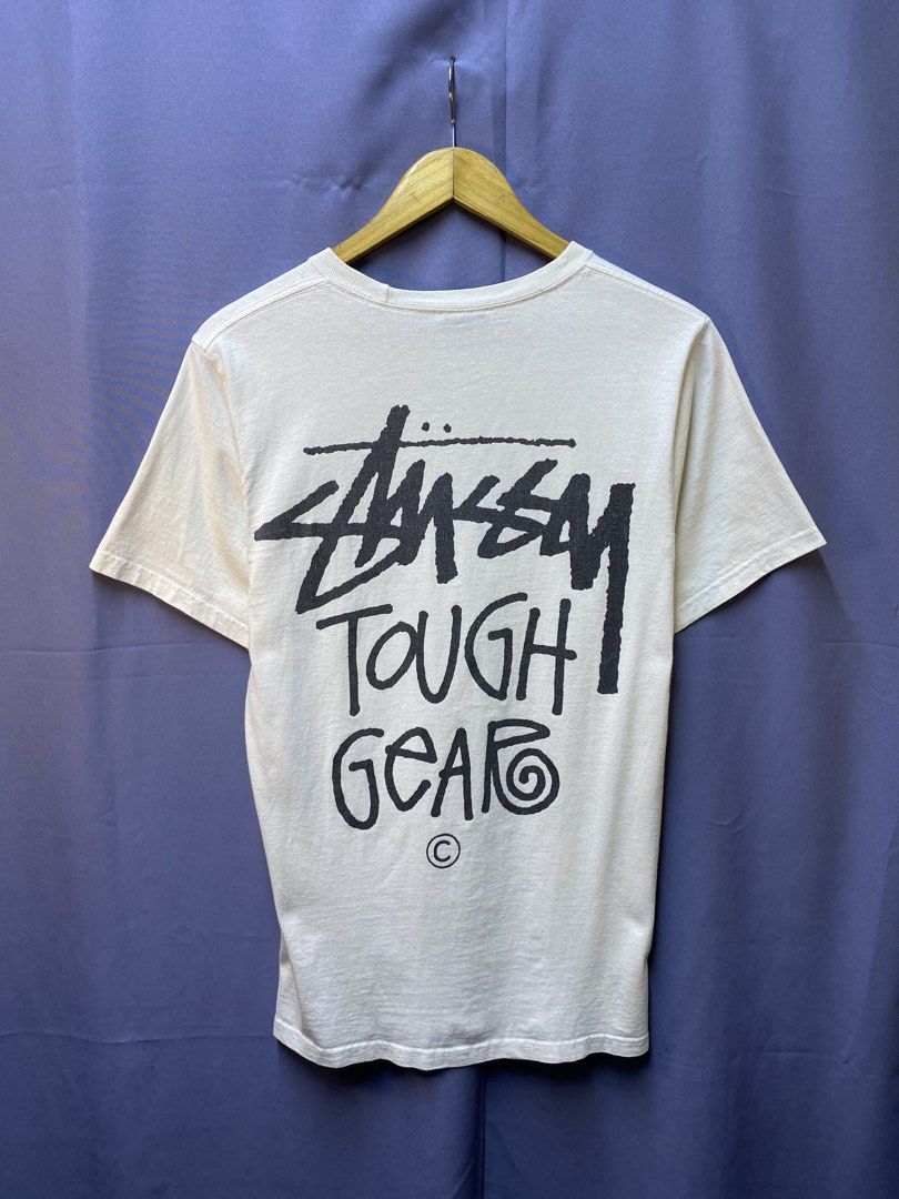 STUSSY “TOUGH GEAR” TEE (Category: Tshirts & Polo Shirts ) located in Makati City. Submitted by drip.poww (Listing ID 1469733491, Image 1). Description: - Authentic Stussy - Color: white - Size: Small - Dimes: 20x28 - Authentic - Excellent condition - Need wash, fresh from bale - Material: 100% Cotton Please don’t expect too much—these are thrifted (ukay) items. 😊 !!STILL NEGOTIABLE!!.