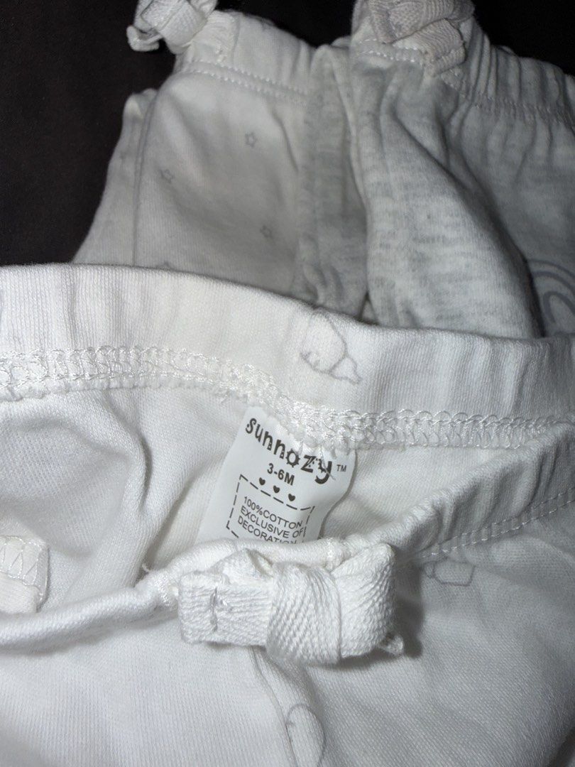 Sunnozy Baby Pants Set 3-6M (Category: Babies & Kids Fashion) located in Dasmarinas. Submitted by denmae (Listing ID 1469632808, Image 2). Description: - Brand: Sunnozy - Size: 3-6 months - Quantity: Bundle of 3 pairs - Material: 100% soft cotton - Designs: White with grey stars, plain grey with 'DREAM BIG' graphic, white with baby bottles - Features: Comfortable elastic waistbands with cute decorative bows - Condition: Brand new / Excellent qual