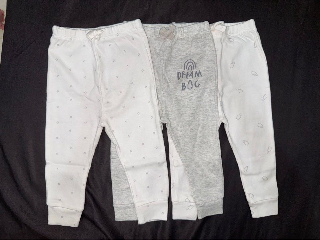 Sunnozy Baby Pants Set 3-6M (Category: Babies & Kids Fashion) located in Dasmarinas. Submitted by denmae (Listing ID 1469632808, Image 1). Description: - Brand: Sunnozy - Size: 3-6 months - Quantity: Bundle of 3 pairs - Material: 100% soft cotton - Designs: White with grey stars, plain grey with 'DREAM BIG' graphic, white with baby bottles - Features: Comfortable elastic waistbands with cute decorative bows - Condition: Brand new / Excellent qual