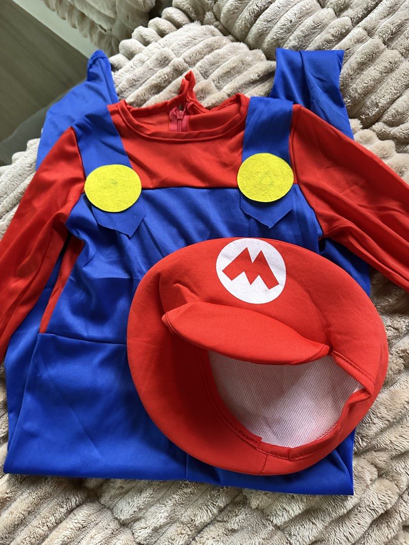 Super Mario Costume With Hat (Category: Babies & Kids Fashion) located in Quezon City. Submitted by ja.layug (Listing ID 1469628340, Image 1). Description: - Complete Set: Includes red and blue long-sleeve jumpsuit with attached yellow buttons and matching red hat with the iconic white 'M' logo - Convenient Design: Features an easy zip-back closure for quick wear and removal - Comfortable Material: Made from smooth, bright fabric for a great look