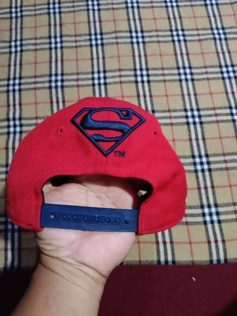 Superman snapback hat red and blue cap (Category: Caps & Hats) located in General Santos City (Dadiangas). Submitted by freehorse.5f2a61 (Listing ID 1469629386, Image 2). Description: - Style: Superman snapback cap - Colors: Red crown with blue flat brim and top button - Design: Bold white embroidered Superman lettering wrapping around the front - Details: Embroidered Superman logo above the adjustable plastic snap closure at the back - Condition