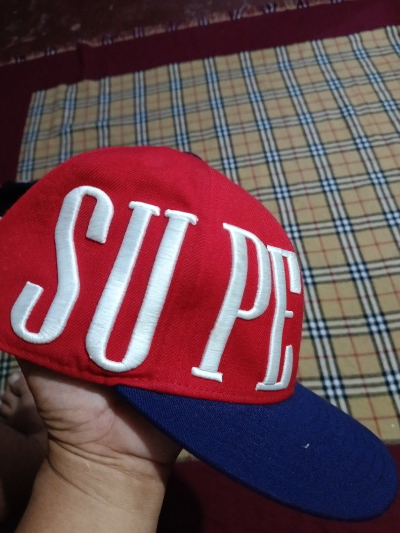 Superman snapback hat red and blue cap (Category: Caps & Hats) located in General Santos City (Dadiangas). Submitted by freehorse.5f2a61 (Listing ID 1469629386, Image 3). Description: - Style: Superman snapback cap - Colors: Red crown with blue flat brim and top button - Design: Bold white embroidered Superman lettering wrapping around the front - Details: Embroidered Superman logo above the adjustable plastic snap closure at the back - Condition