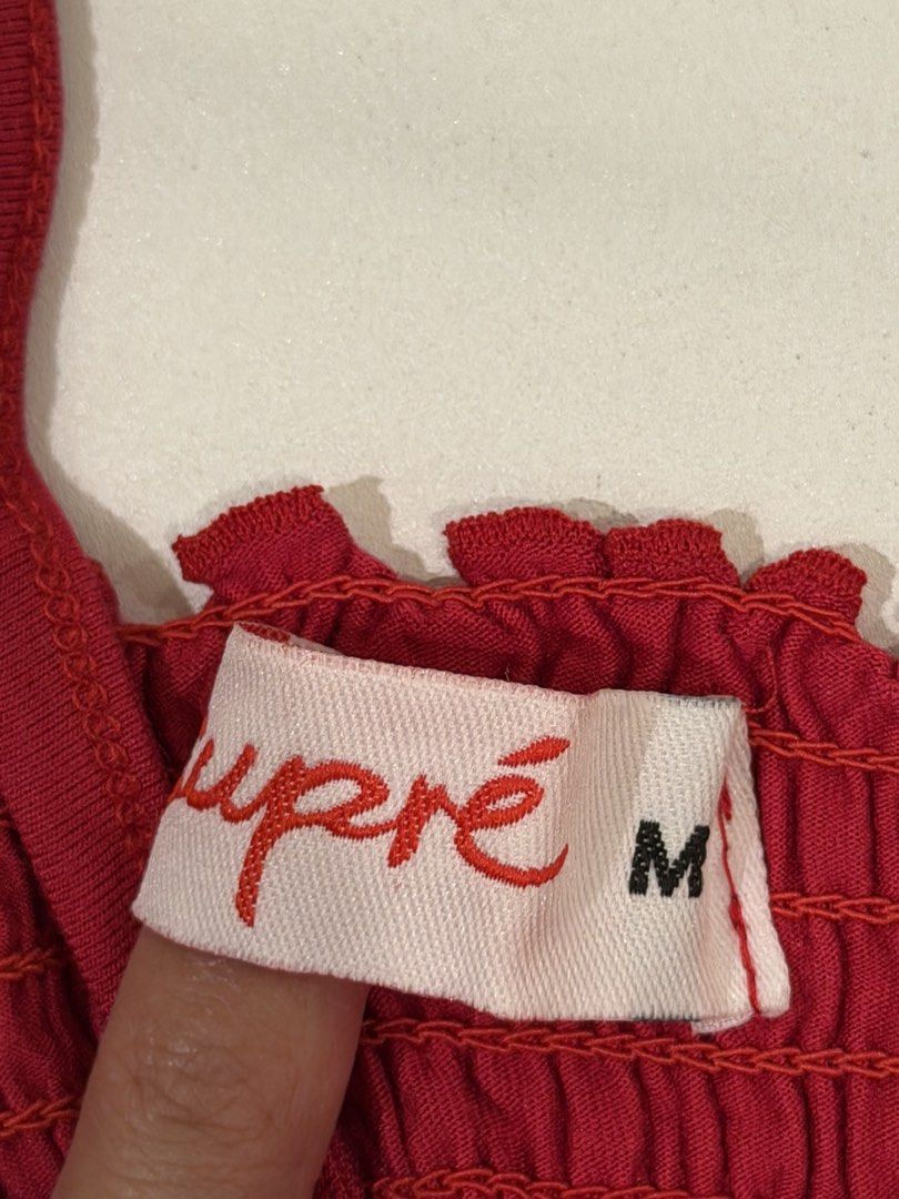Supré Red Smocked Crop Top Size M (Category: Blouses) located in Muntinlupa City. Submitted by henlo03 (Listing ID 1469611270, Image 2). Description: - Brand: Supré - Size: M - Color: Bright red - Material: Stretchy all-over smocked fabric - Design: V-neckline with skinny straps and trendy lettuce hem details - Condition: like new.