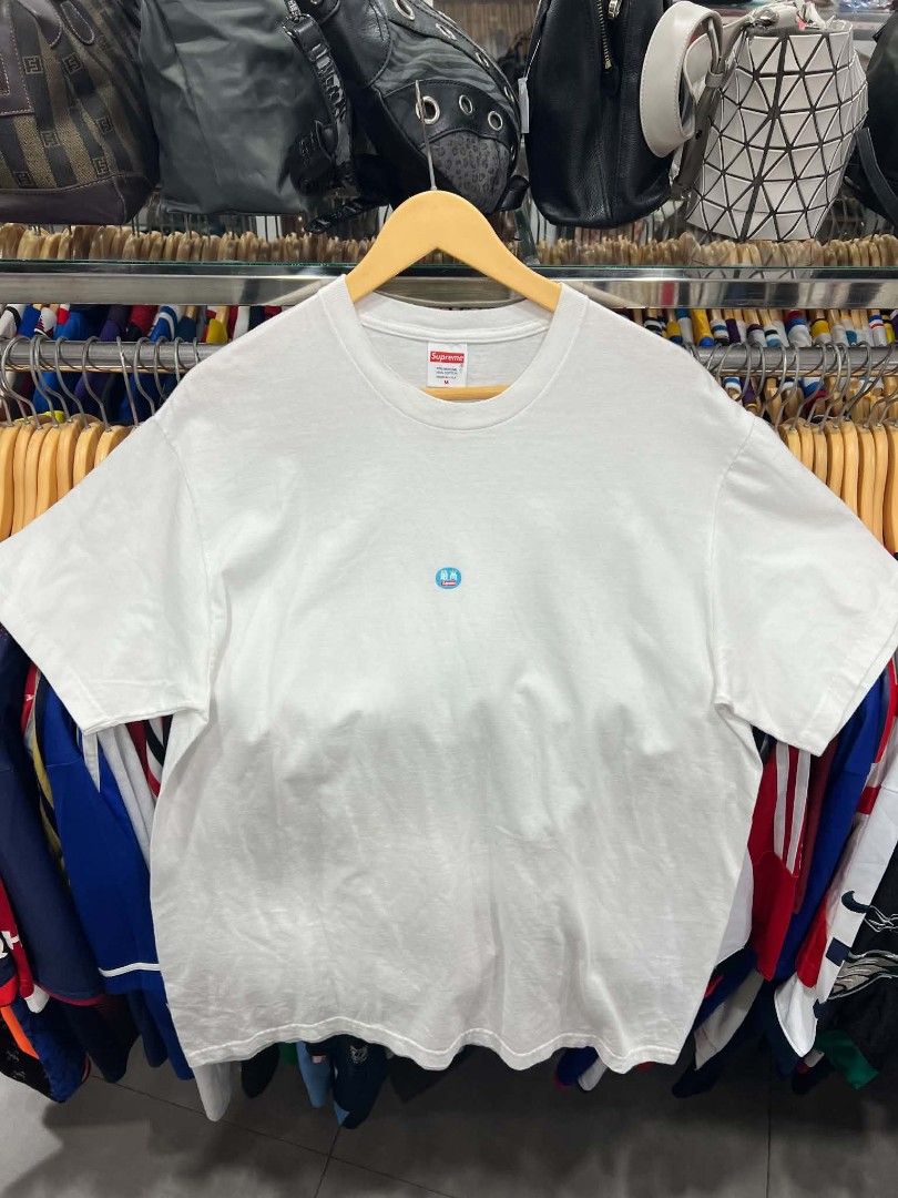 Supreme White T-Shirt Size M (Category: Tshirts & Polo Shirts ) located in Urdaneta. Submitted by jayceegarage (Listing ID 1469672712, Image 1). Description: - Brand: Supreme - Authentic supreme - Style: Crewneck t-shirt - Color: White - Need wash dot stain - Size: Medium - Material: 100% pre-shrunk cotton (Made in USA) - Design: Small blue circular graphic on chest with Japanese text and Supreme logo - Authenticity: Standard collar tag and inter