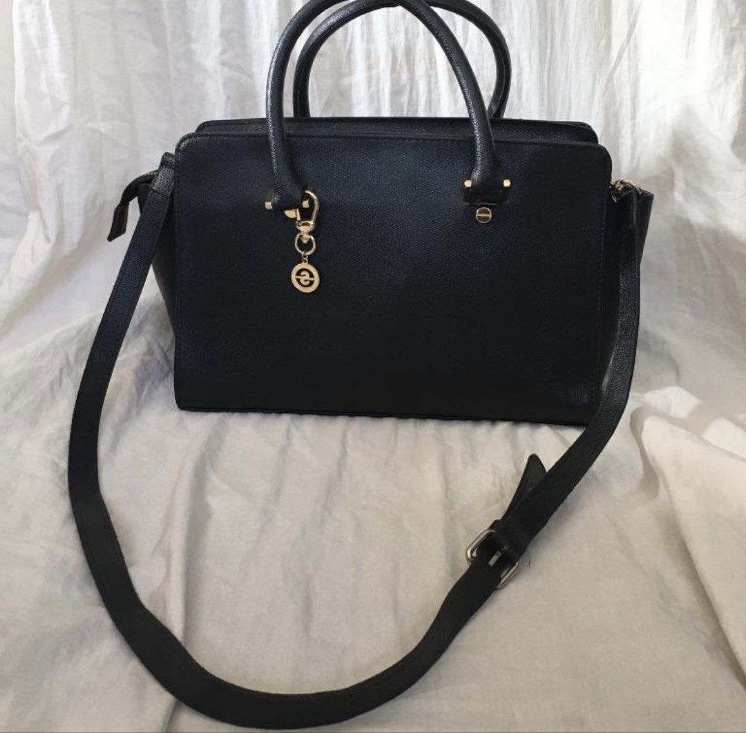 Suze La Rousse Black Handbag with Strap (Category: Shoulder Bags) located in Paranaque City. Submitted by craftywoobieph (Listing ID 1469662731, Image 1). Description: - Brand: Suze La Rousse - Color: Black with chic gold-tone hardware - Features: Structured design, top handles, and an adjustable shoulder strap - Details: Includes a stylish branded logo charm - Interior: Black fabric lining with one zippered pocket - Condition: Good, with some mi