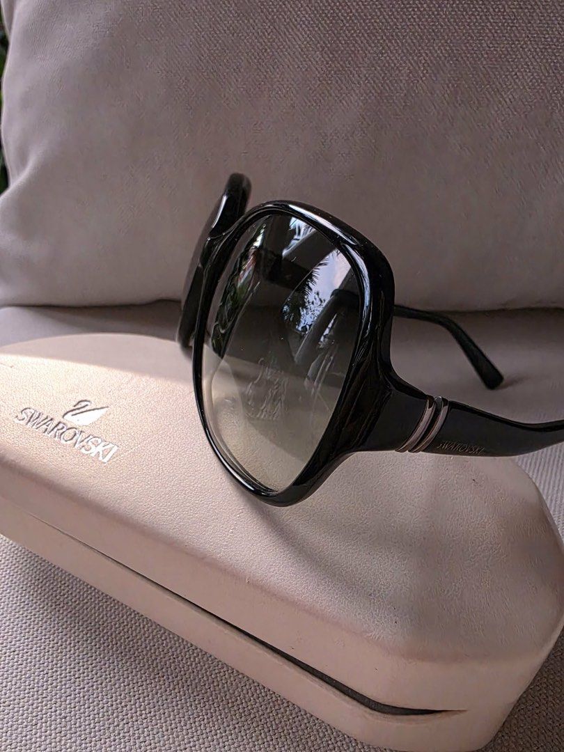 Swarovski black oversized sunglasses with case (Category: Sunglasses & Eyewear) located in Paranaque City. Submitted by dsthings (Listing ID 1469613045, Image 2). Description: - Brand: Swarovski Asia SW11 - Lenses: Dark gradient lenses with Swan temple accents - Details: Signature silver branding on the temples - Inclusion: Original hard case - Condition: Lightly used.