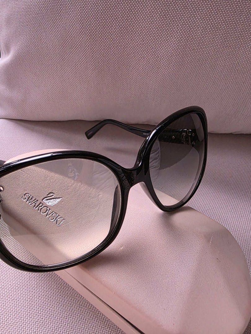 Swarovski black oversized sunglasses with case (Category: Sunglasses & Eyewear) located in Paranaque City. Submitted by dsthings (Listing ID 1469613045, Image 3). Description: - Brand: Swarovski Asia SW11 - Lenses: Dark gradient lenses with Swan temple accents - Details: Signature silver branding on the temples - Inclusion: Original hard case - Condition: Lightly used.